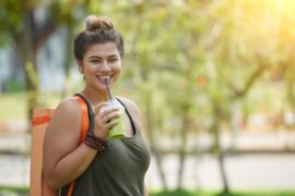 Sporty girl drinking smoothie